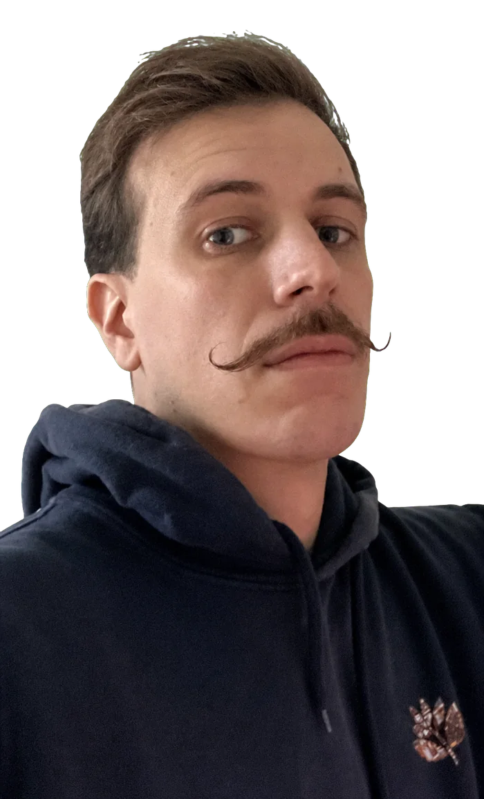Portrait of Droppy wearing a dark hoodie and a curled moustache